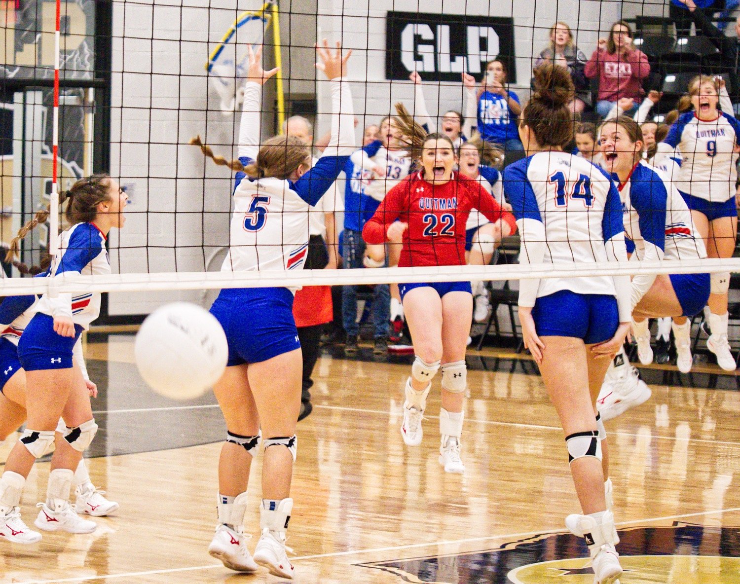 The Lady Bulldogs react to winning match point, prevailing over Redwater to claim a bi-district title. [See the entire set of photos.]